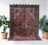 Antique Persian area rug in a living room setting, pile rug, vintage rug, portland, rug shop, bright colors, wild shaman, soft rug, bold color, Portland, Oregon, rug store, rug shop, local shop, antique rug, Persian rug, handmade rug, wool rug, distressed rug