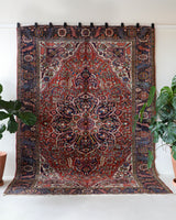 Antique Persian area rug in a living room setting, pile rug, vintage rug, portland, rug shop, bright colors, wild shaman, soft rug, bold color, Portland, Oregon, rug store, rug shop, local shop, antique rug, Persian rug, handmade rug, wool rug, distressed rug