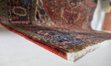 Antique Persian area rug in a living room setting, pile rug, vintage rug, portland, rug shop, bright colors, wild shaman, soft rug, bold color, Portland, Oregon, rug store, rug shop, local shop, antique rug, Persian rug, handmade rug, wool rug, distressed rug