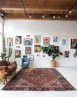 Antique Persian area rug in a living room setting, pile rug, vintage rug, portland, rug shop, bright colors, wild shaman, soft rug, bold color, Portland, Oregon, rug store, rug shop, local shop, antique rug, Persian rug, handmade rug, wool rug, distressed rug