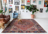 Antique Persian area rug in a living room setting, pile rug, vintage rug, portland, rug shop, bright colors, wild shaman, soft rug, bold color, Portland, Oregon, rug store, rug shop, local shop, antique rug, Persian rug, handmade rug, wool rug, distressed rug