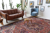 Antique Persian area rug in a living room setting, pile rug, vintage rug, portland, rug shop, bright colors, wild shaman, soft rug, bold color, Portland, Oregon, rug store, rug shop, local shop, antique rug, Persian rug, handmade rug, wool rug, distressed rug