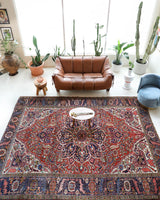 Antique Persian area rug in a living room setting, pile rug, vintage rug, portland, rug shop, bright colors, wild shaman, soft rug, bold color, Portland, Oregon, rug store, rug shop, local shop, antique rug, Persian rug, handmade rug, wool rug, distressed rug