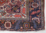 Antique Persian area rug in a living room setting, pile rug, vintage rug, portland, rug shop, bright colors, wild shaman, soft rug, bold color, Portland, Oregon, rug store, rug shop, local shop, antique rug, Persian rug, handmade rug, wool rug, distressed rug