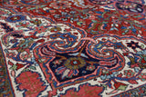 Antique Persian area rug in a living room setting, pile rug, vintage rug, portland, rug shop, bright colors, wild shaman, soft rug, bold color, Portland, Oregon, rug store, rug shop, local shop, antique rug, Persian rug, handmade rug, wool rug, distressed rug