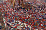 Antique Persian area rug in a living room setting, pile rug, vintage rug, portland, rug shop, bright colors, wild shaman, soft rug, bold color, Portland, Oregon, rug store, rug shop, local shop, antique rug, Persian rug, handmade rug, wool rug, distressed rug