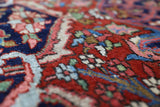Antique Persian area rug in a living room setting, pile rug, vintage rug, portland, rug shop, bright colors, wild shaman, soft rug, bold color, Portland, Oregon, rug store, rug shop, local shop, antique rug, Persian rug, handmade rug, wool rug, distressed rug