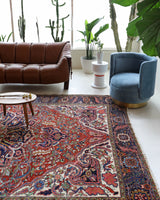 Antique Persian area rug in a living room setting, pile rug, vintage rug, portland, rug shop, bright colors, wild shaman, soft rug, bold color, Portland, Oregon, rug store, rug shop, local shop, antique rug, Persian rug, handmade rug, wool rug, distressed rug