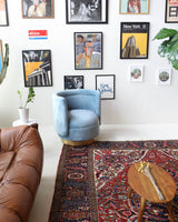 Antique Persian area rug in a living room setting, pile rug, vintage rug, portland, rug shop, bright colors, wild shaman, soft rug, bold color, Portland, Oregon, rug store, rug shop, local shop, antique rug, Persian rug, handmade rug, wool rug, distressed rug