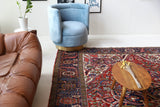 Antique Persian area rug in a living room setting, pile rug, vintage rug, portland, rug shop, bright colors, wild shaman, soft rug, bold color, Portland, Oregon, rug store, rug shop, local shop, antique rug, Persian rug, handmade rug, wool rug, distressed rug