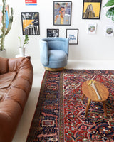 Antique Persian area rug in a living room setting, pile rug, vintage rug, portland, rug shop, bright colors, wild shaman, soft rug, bold color, Portland, Oregon, rug store, rug shop, local shop, antique rug, Persian rug, handmade rug, wool rug, distressed rug