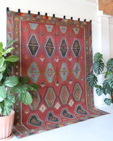 Vintage kilim rug in living room setting, old rug, antique rug, pastel colors, faded colors, Turkish rug, vintage rug, soft rug, Portland, Oregon, rug store, rug shop, local shop, earthy tones, earthy colors, warm colors