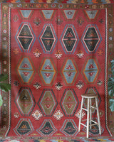 Vintage kilim rug in living room setting, old rug, antique rug, pastel colors, faded colors, Turkish rug, vintage rug, soft rug, Portland, Oregon, rug store, rug shop, local shop, earthy tones, earthy colors, warm colors