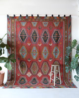 Vintage kilim rug in living room setting, old rug, antique rug, pastel colors, faded colors, Turkish rug, vintage rug, soft rug, Portland, Oregon, rug store, rug shop, local shop, earthy tones, earthy colors, warm colors
