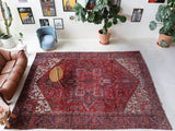 Antique Persian area rug in a living room setting, pile rug, vintage rug, portland, rug shop, bright colors, wild shaman, soft rug, bold color, Portland, Oregon, rug store, rug shop, local shop, antique rug, Persian rug, handmade rug, wool rug, distressed rug