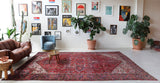 Antique Persian area rug in a living room setting, pile rug, vintage rug, portland, rug shop, bright colors, wild shaman, soft rug, bold color, Portland, Oregon, rug store, rug shop, local shop, antique rug, Persian rug, handmade rug, wool rug, distressed rug