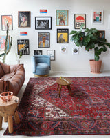 Antique Persian area rug in a living room setting, pile rug, vintage rug, portland, rug shop, bright colors, wild shaman, soft rug, bold color, Portland, Oregon, rug store, rug shop, local shop, antique rug, Persian rug, handmade rug, wool rug, distressed rug