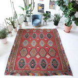 Vintage kilim rug in living room setting, old rug, antique rug, pastel colors, faded colors, Turkish rug, vintage rug, soft rug, Portland, Oregon, rug store, rug shop, local shop, earthy tones, earthy colors, warm colors