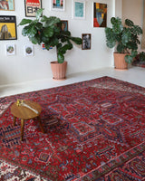Antique Persian area rug in a living room setting, pile rug, vintage rug, portland, rug shop, bright colors, wild shaman, soft rug, bold color, Portland, Oregon, rug store, rug shop, local shop, antique rug, Persian rug, handmade rug, wool rug, distressed rug