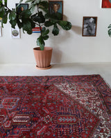 Antique Persian area rug in a living room setting, pile rug, vintage rug, portland, rug shop, bright colors, wild shaman, soft rug, bold color, Portland, Oregon, rug store, rug shop, local shop, antique rug, Persian rug, handmade rug, wool rug, distressed rug