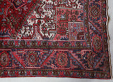 Antique Persian area rug in a living room setting, pile rug, vintage rug, portland, rug shop, bright colors, wild shaman, soft rug, bold color, Portland, Oregon, rug store, rug shop, local shop, antique rug, Persian rug, handmade rug, wool rug, distressed rug