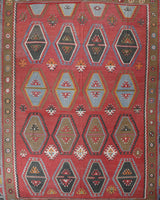 Vintage kilim rug in living room setting, old rug, antique rug, pastel colors, faded colors, Turkish rug, vintage rug, soft rug, Portland, Oregon, rug store, rug shop, local shop, earthy tones, earthy colors, warm colors