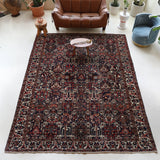 Antique Persian area rug in a living room setting, pile rug, vintage rug, portland, rug shop, bright colors, wild shaman, soft rug, bold color, Portland, Oregon, rug store, rug shop, local shop, antique rug, Persian rug, handmade rug, wool rug, distressed rug