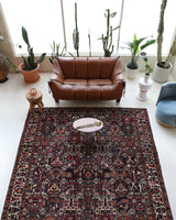 Antique Persian area rug in a living room setting, pile rug, vintage rug, portland, rug shop, bright colors, wild shaman, soft rug, bold color, Portland, Oregon, rug store, rug shop, local shop, antique rug, Persian rug, handmade rug, wool rug, distressed rug