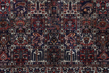 Antique Persian area rug in a living room setting, pile rug, vintage rug, portland, rug shop, bright colors, wild shaman, soft rug, bold color, Portland, Oregon, rug store, rug shop, local shop, antique rug, Persian rug, handmade rug, wool rug, distressed rug
