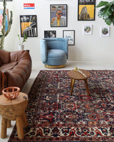Antique Persian area rug in a living room setting, pile rug, vintage rug, portland, rug shop, bright colors, wild shaman, soft rug, bold color, Portland, Oregon, rug store, rug shop, local shop, antique rug, Persian rug, handmade rug, wool rug, distressed rug