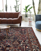 Antique Persian area rug in a living room setting, pile rug, vintage rug, portland, rug shop, bright colors, wild shaman, soft rug, bold color, Portland, Oregon, rug store, rug shop, local shop, antique rug, Persian rug, handmade rug, wool rug, distressed rug