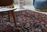 Antique Persian area rug in a living room setting, pile rug, vintage rug, portland, rug shop, bright colors, wild shaman, soft rug, bold color, Portland, Oregon, rug store, rug shop, local shop, antique rug, Persian rug, handmade rug, wool rug, distressed rug