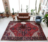 Antique Persian area rug in a living room setting, pile rug, vintage rug, portland, rug shop, bright colors, wild shaman, soft rug, bold color, Portland, Oregon, rug store, rug shop, local shop, antique rug, Persian rug, handmade rug, wool rug, distressed rug