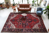Antique Persian area rug in a living room setting, pile rug, vintage rug, portland, rug shop, bright colors, wild shaman, soft rug, bold color, Portland, Oregon, rug store, rug shop, local shop, antique rug, Persian rug, handmade rug, wool rug, distressed rug