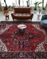 Antique Persian area rug in a living room setting, pile rug, vintage rug, portland, rug shop, bright colors, wild shaman, soft rug, bold color, Portland, Oregon, rug store, rug shop, local shop, antique rug, Persian rug, handmade rug, wool rug, distressed rug