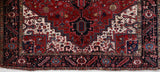 Antique Persian area rug in a living room setting, pile rug, vintage rug, portland, rug shop, bright colors, wild shaman, soft rug, bold color, Portland, Oregon, rug store, rug shop, local shop, antique rug, Persian rug, handmade rug, wool rug, distressed rug