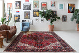Antique Persian area rug in a living room setting, pile rug, vintage rug, portland, rug shop, bright colors, wild shaman, soft rug, bold color, Portland, Oregon, rug store, rug shop, local shop, antique rug, Persian rug, handmade rug, wool rug, distressed rug