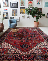 Antique Persian area rug in a living room setting, pile rug, vintage rug, portland, rug shop, bright colors, wild shaman, soft rug, bold color, Portland, Oregon, rug store, rug shop, local shop, antique rug, Persian rug, handmade rug, wool rug, distressed rug