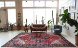 Antique Persian area rug in a living room setting, pile rug, vintage rug, portland, rug shop, bright colors, wild shaman, soft rug, bold color, Portland, Oregon, rug store, rug shop, local shop, antique rug, Persian rug, handmade rug, wool rug, distressed rug