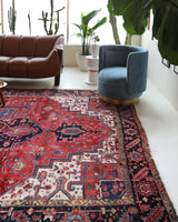 Antique Persian area rug in a living room setting, pile rug, vintage rug, portland, rug shop, bright colors, wild shaman, soft rug, bold color, Portland, Oregon, rug store, rug shop, local shop, antique rug, Persian rug, handmade rug, wool rug, distressed rug