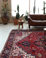 Antique Persian area rug in a living room setting, pile rug, vintage rug, portland, rug shop, bright colors, wild shaman, soft rug, bold color, Portland, Oregon, rug store, rug shop, local shop, antique rug, Persian rug, handmade rug, wool rug, distressed rug