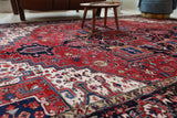 Antique Persian area rug in a living room setting, pile rug, vintage rug, portland, rug shop, bright colors, wild shaman, soft rug, bold color, Portland, Oregon, rug store, rug shop, local shop, antique rug, Persian rug, handmade rug, wool rug, distressed rug