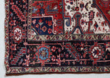 Antique Persian area rug in a living room setting, pile rug, vintage rug, portland, rug shop, bright colors, wild shaman, soft rug, bold color, Portland, Oregon, rug store, rug shop, local shop, antique rug, Persian rug, handmade rug, wool rug, distressed rug