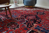 Antique Persian area rug in a living room setting, pile rug, vintage rug, portland, rug shop, bright colors, wild shaman, soft rug, bold color, Portland, Oregon, rug store, rug shop, local shop, antique rug, Persian rug, handmade rug, wool rug, distressed rug