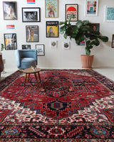 Antique Persian area rug in a living room setting, pile rug, vintage rug, portland, rug shop, bright colors, wild shaman, soft rug, bold color, Portland, Oregon, rug store, rug shop, local shop, antique rug, Persian rug, handmade rug, wool rug, distressed rug
