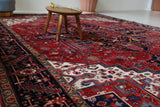 Antique Persian area rug in a living room setting, pile rug, vintage rug, portland, rug shop, bright colors, wild shaman, soft rug, bold color, Portland, Oregon, rug store, rug shop, local shop, antique rug, Persian rug, handmade rug, wool rug, distressed rug