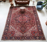 Antique Persian area rug in a living room setting, pile rug, vintage rug, portland, rug shop, bright colors, wild shaman, soft rug, bold color, Portland, Oregon, rug store, rug shop, local shop, antique rug, Persian rug, handmade rug, wool rug, distressed rug