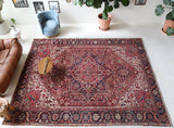 Antique Persian area rug in a living room setting, pile rug, vintage rug, portland, rug shop, bright colors, wild shaman, soft rug, bold color, Portland, Oregon, rug store, rug shop, local shop, antique rug, Persian rug, handmade rug, wool rug, distressed rug