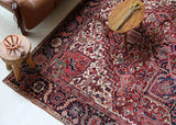 Antique Persian area rug in a living room setting, pile rug, vintage rug, portland, rug shop, bright colors, wild shaman, soft rug, bold color, Portland, Oregon, rug store, rug shop, local shop, antique rug, Persian rug, handmade rug, wool rug, distressed rug