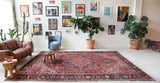 Antique Persian area rug in a living room setting, pile rug, vintage rug, portland, rug shop, bright colors, wild shaman, soft rug, bold color, Portland, Oregon, rug store, rug shop, local shop, antique rug, Persian rug, handmade rug, wool rug, distressed rug